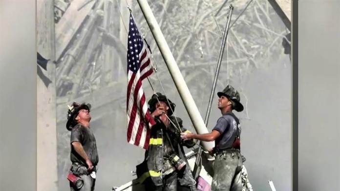 Eight hours after the attack, three firemen took an American flag off a yacht and raised it in the wreckage. The moment, captured by Thomas E. Franklin, was the most memorable flag raising since Iwo Jima. A year after the attacks, Franklin reunited with the trio for a new photo, this time with the Statue of Liberty as the background.