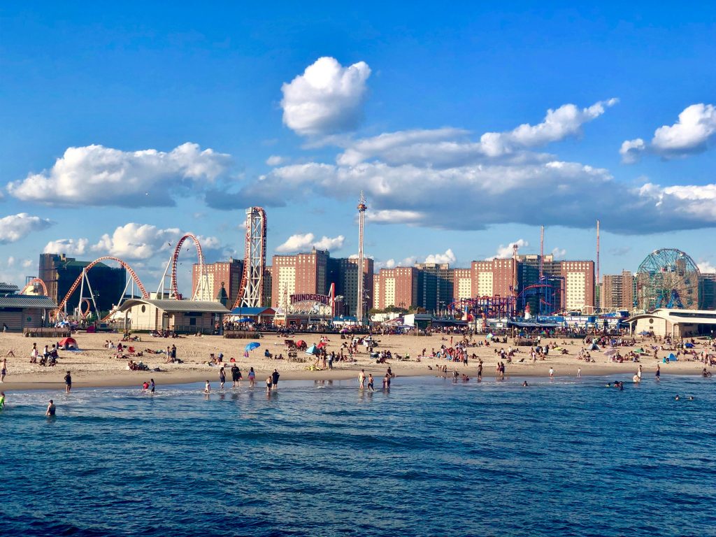 Beat the Heat: 10 Refreshing Ways to Cool Down in NYC This July 3 People swimming on the beach