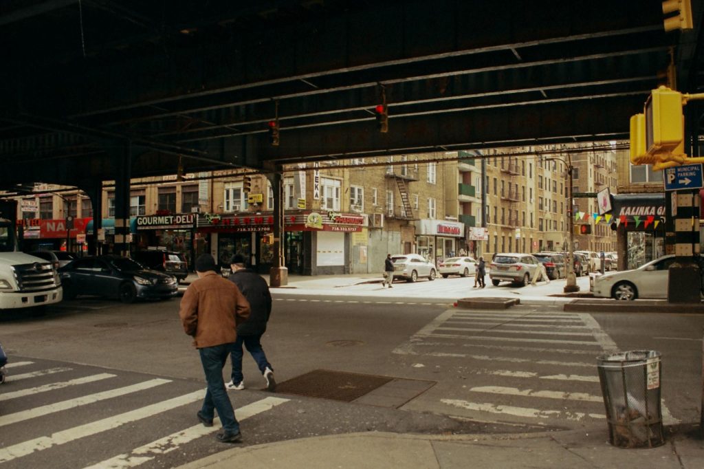 men crossing street in a city